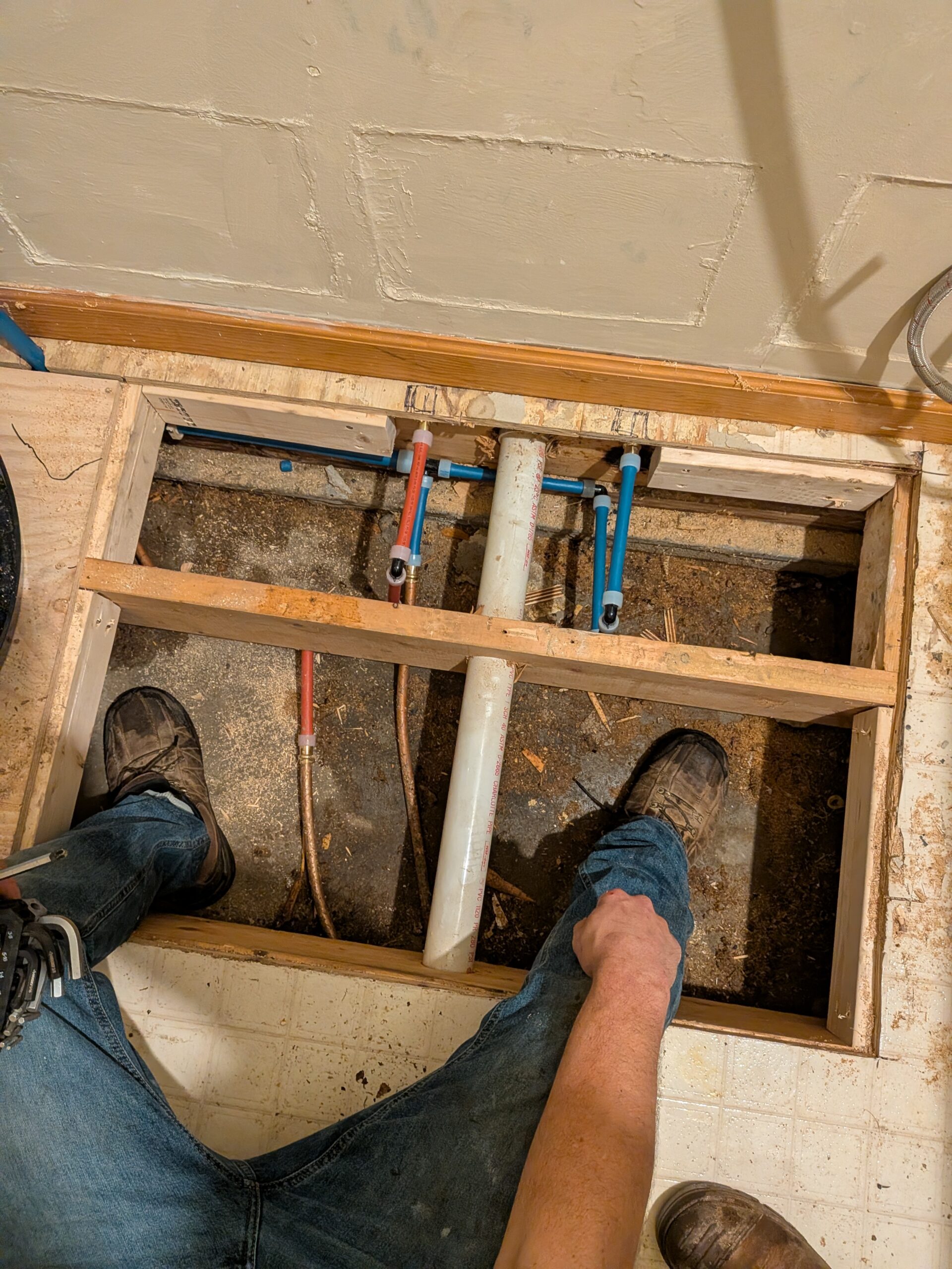 Non-invasive main water line repair under a residential subfloor
